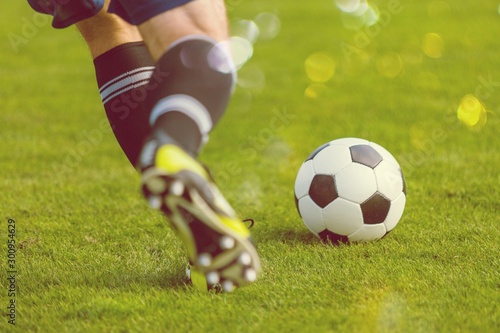 Running soccer player. Soccer football background. © BillionPhotos.com