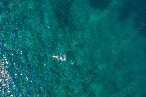 Bright blue-turquoise surface of the sea with a lone diver. Shooting from a drone. © ROMAN DZIUBALO