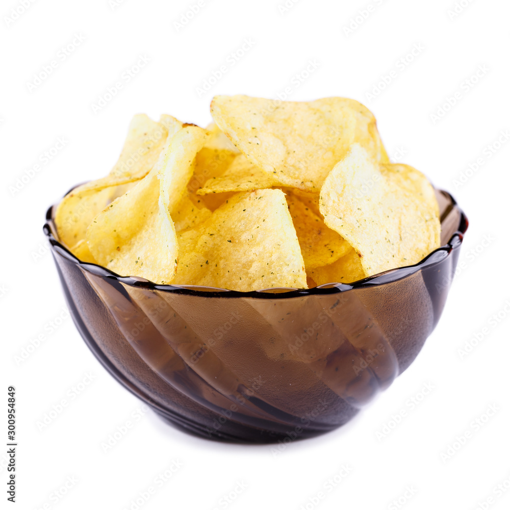 Potato chips falling in the plate. Isolated on white background
