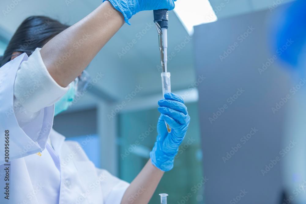 The scientists injected chemicals into plastic tubes,Scientist mix chemicals with The shake machine Before the experiment.Mixture laced with samples into test tubes,prepare sample for test The scientists injected chemicals into plastic tubes,Scientist mix chemicals with The shake machine Before the experiment.Mixture laced with samples into test tubes,prepare sample for test