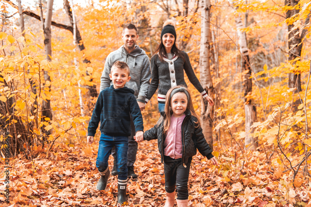 A portrait of a young family in the autumn park A portrait of a young family in the autumn park