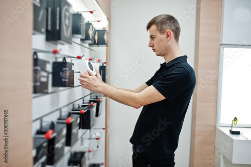 Seller man mobile phone professional consultant in tech store or shop.