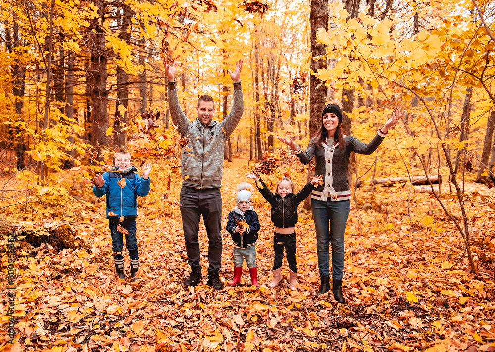 A portrait of a young family in the autumn park