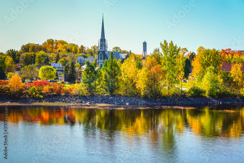 Autumn Landscape View with Church and Colorful Trees Reflected in Water