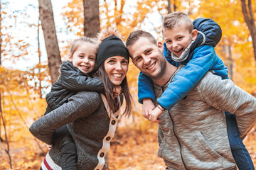 A portrait of a young family in the autumn park