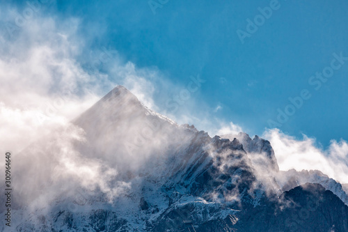 Snow-capped mountain peak in the Alps against a blue sky