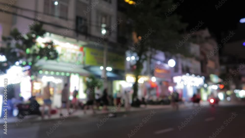 Vietnam's evening streets with lighting from shops, signboards, passing mopeds, motorbikes, cars and carts Vietnam's evening streets with lighting from shops, signboards, passing mopeds, motorbikes, cars and carts