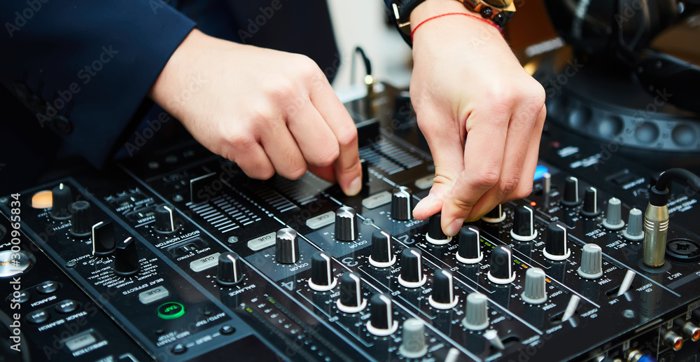Dj mixes the track in the nightclub at party Dj mixes the track in the nightclub at party
