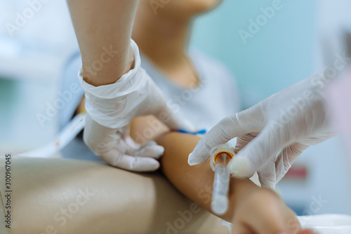 A nurse takes blood for analysis in the treatment room