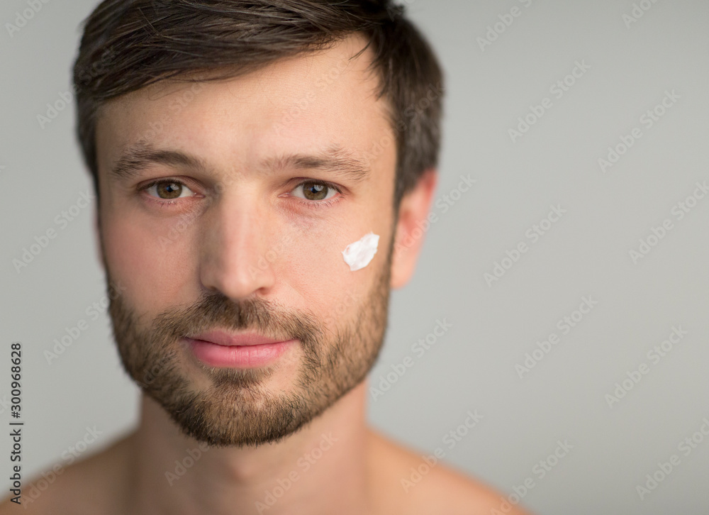 Middle Aged Man Applying Face Cream Over Gray Background Middle Aged Man Applying Face Cream Over Gray Background