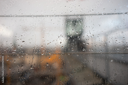 Window with raindrops with blurred background of stockholm