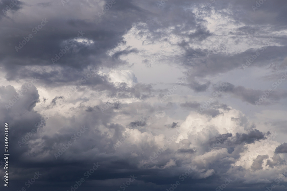 Storm cumulus fluffy clouds texture closeup, dark grey sky background texture	