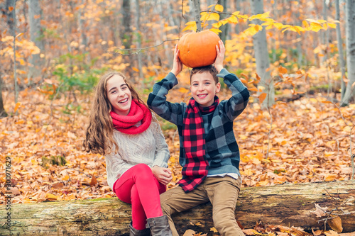 portrait of two child brother and sister in the autumn season outside