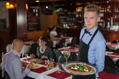 Waiter with serving tray meeting guests