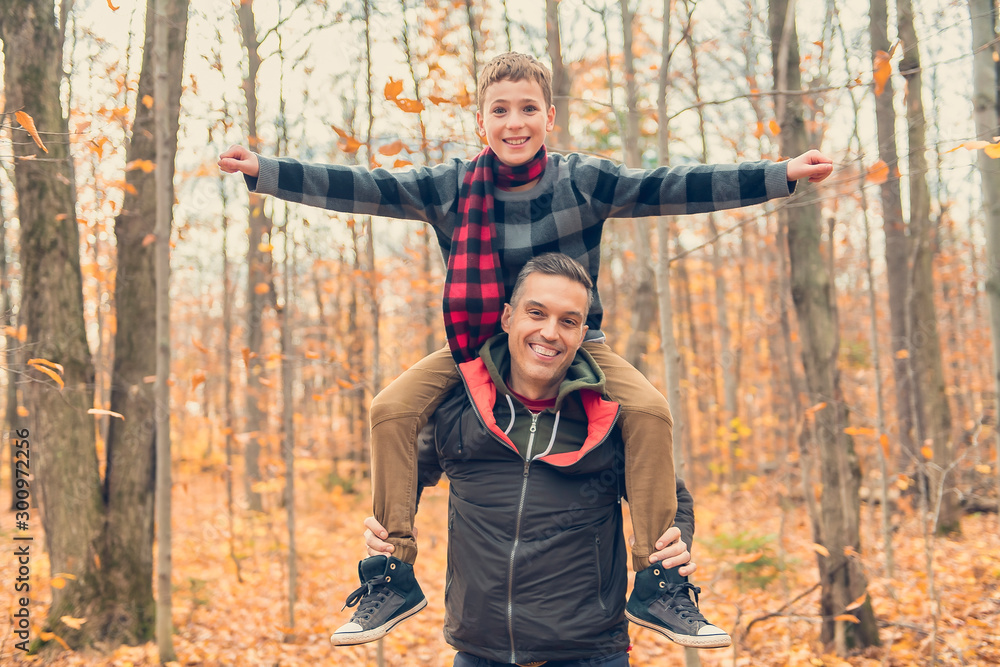 A portrait of a father with child in the autumn park A portrait of a father with child in the autumn park