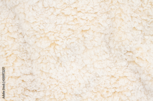 Beige sherpa textured plush fabric material background