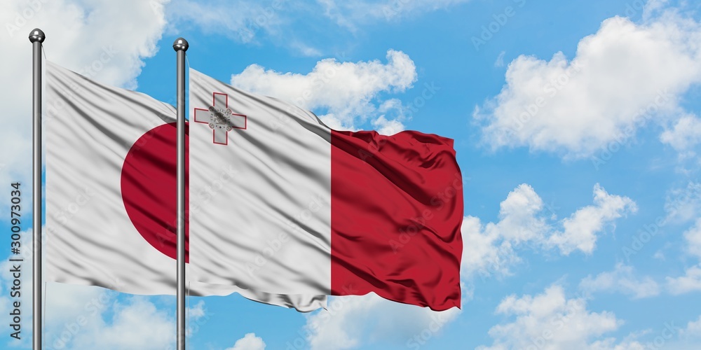 Japan and Malta flag waving in the wind against white cloudy blue sky together. Diplomacy concept, international relations.