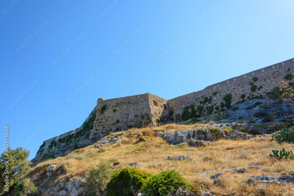 view of the stone wall of the fortress of Fortezza on the mountain. Greece, Rethymno.