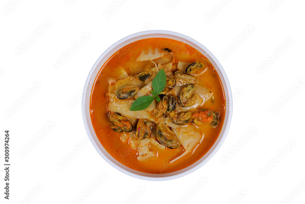 Coconut Milk Curry with bamboo shoot and green mussel in bowl on wood table isolated on white background