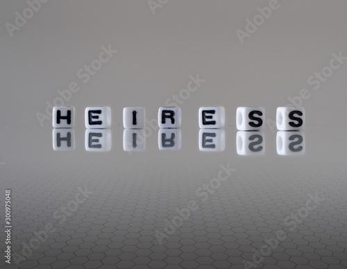 Obraz na plátně The concept of heiress represented by wooden letter tiles