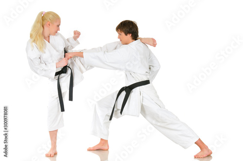 Beautiful young girl and a young cheeky guy karate