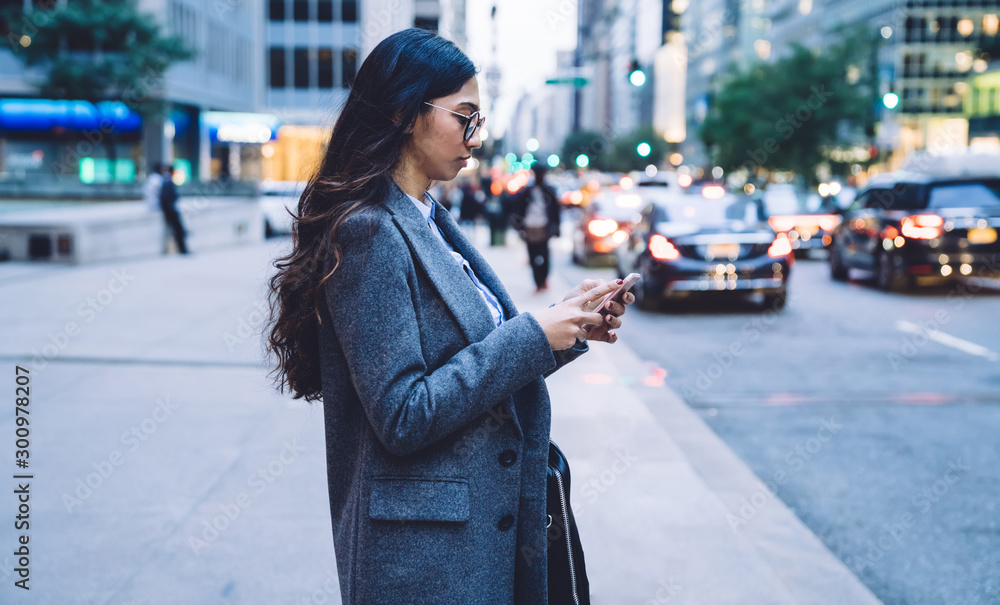 Fototapeta premium Asian female using mobile phone in downtown