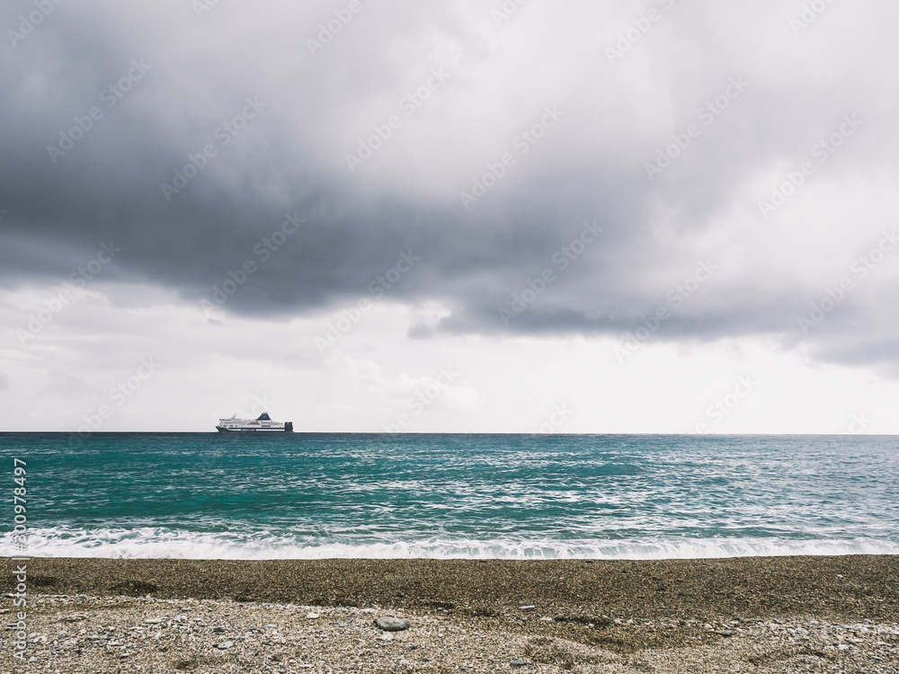 beautiful seascape with cloudy sky, sandy beach and a ship on the horizon beautiful seascape with cloudy sky, sandy beach and a ship on the horizon