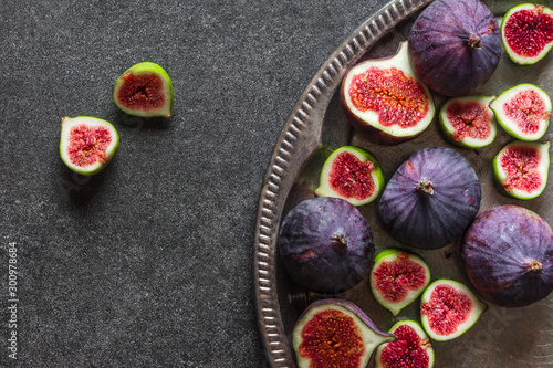 Fresh fig fruits. Blue figs slices on plate.