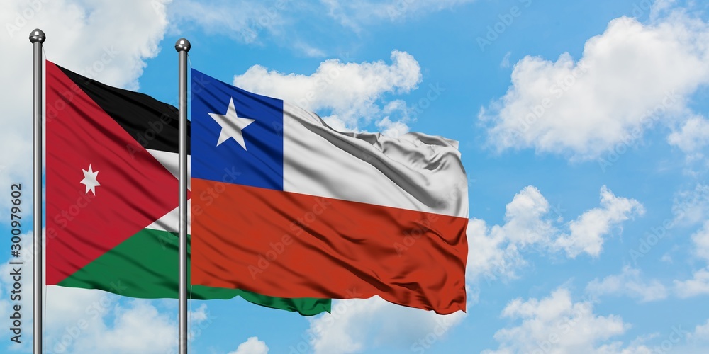 Jordan and Chile flag waving in the wind against white cloudy blue sky together. Diplomacy concept, international relations.