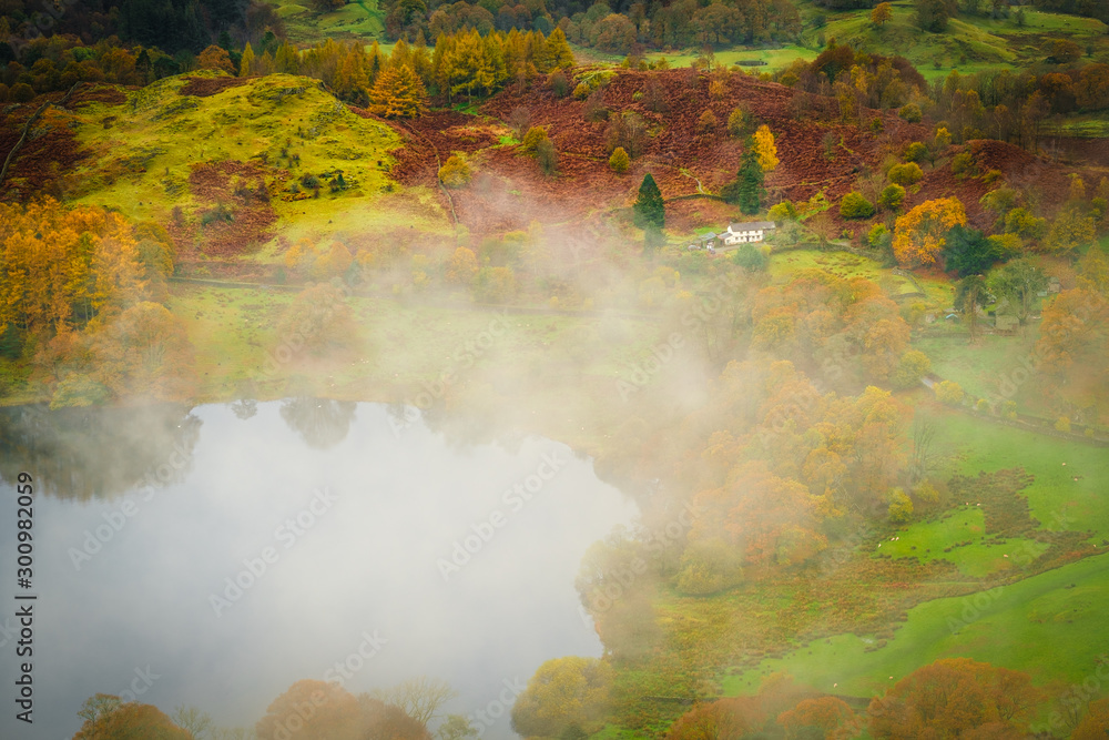 Mist over Loughrigg Tarn in the English Lake District Mist over Loughrigg Tarn in the English Lake District