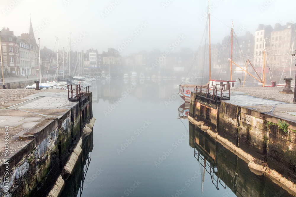 Fototapeta premium Honfleur port (France) in fog, hoses and ships