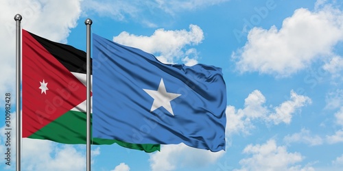 Jordan and Somalia flag waving in the wind against white cloudy blue sky together. Diplomacy concept, international relations.