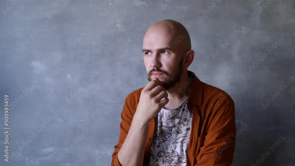 Portrait of a smiling handsome middle aged bald man with beard. Concept of lifestyle, achievement, father Portrait of a smiling handsome middle aged bald man with beard. Concept of lifestyle, achievement, father