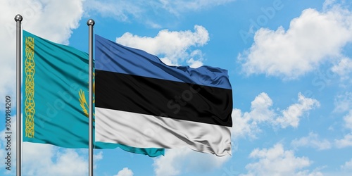 Kazakhstan and Estonia flag waving in the wind against white cloudy blue sky together. Diplomacy concept, international relations.