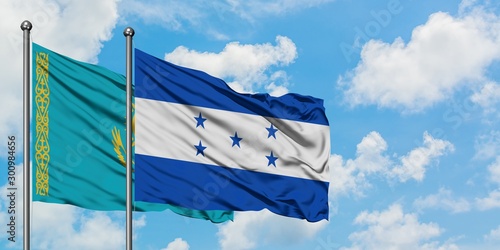Kazakhstan and Honduras flag waving in the wind against white cloudy blue sky together. Diplomacy concept, international relations.