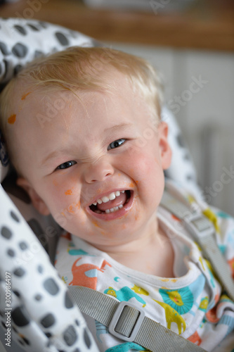 Baby smiling in a highchair