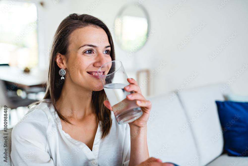 Brunette having good time on the living room with water glass Brunette having good time on the living room with water glass