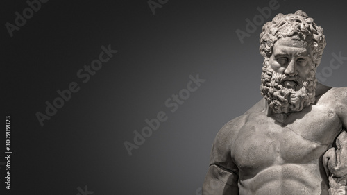 Banner with statue of powerful and handsome bearded Hercules at smooth gradient grey background and paste space, closeup, details photo