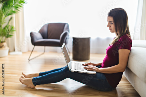 Brunette having good time on the living room with laptop
