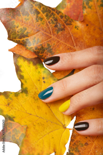 Autumn colors manicure on short round natural nails with leaves