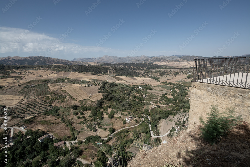 Scenic viewpoint to valley and mountains from Ronda, small ancient white town in Andalusia, Spain