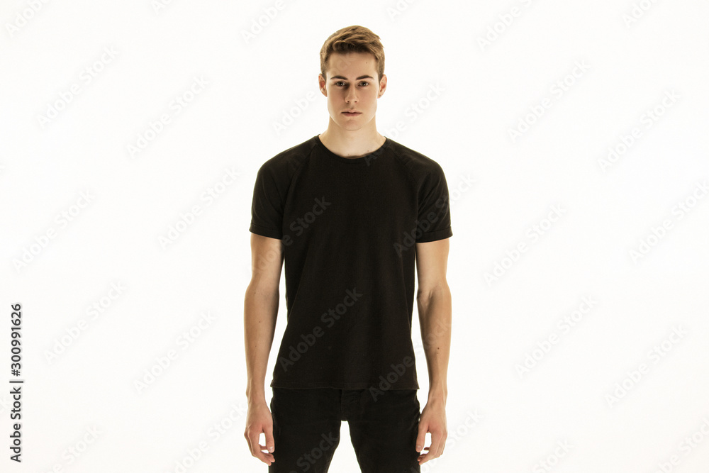 Muscle strong beautiful stripped male model in denim jeans and black t-shirt with belt on white isolated font background Muscle strong beautiful stripped male model in denim jeans and black t-shirt with belt on white isolated font background