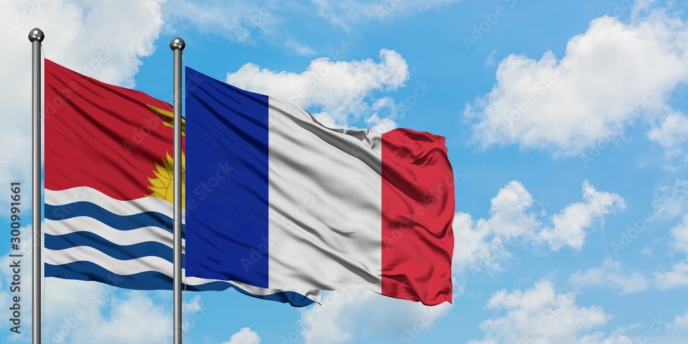 Kiribati and France flag waving in the wind against white cloudy blue sky together. Diplomacy concept, international relations.