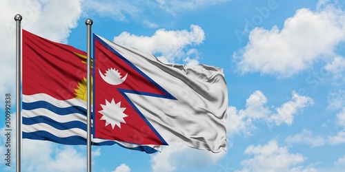 Kiribati and Nepal flag waving in the wind against white cloudy blue sky together. Diplomacy concept, international relations.