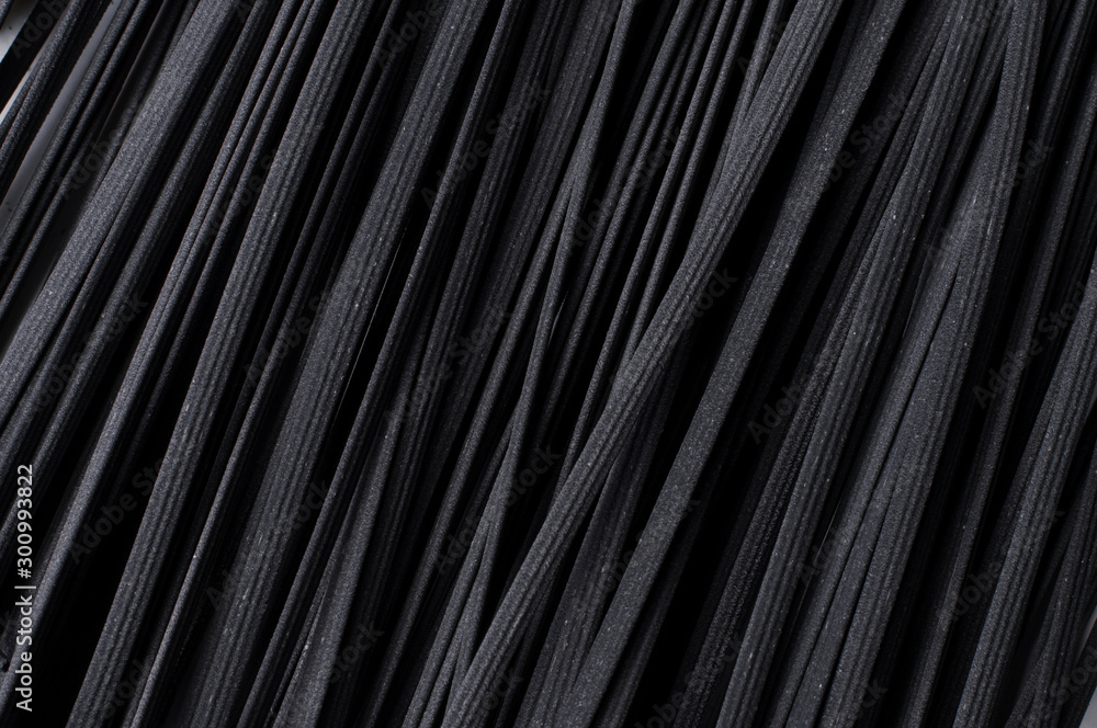 Italian spaghetti close-up shooting.Background texture.black spaghetti. Italian spaghetti close-up shooting.Background texture.black spaghetti.