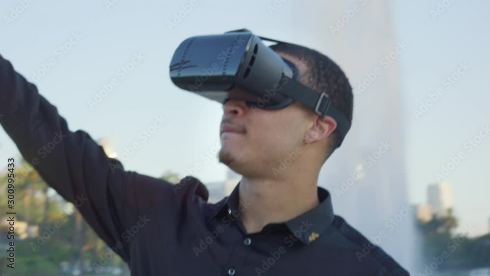 Young african american man wearing VR glasses as he plays at a park Young african american man wearing VR glasses as he plays at a park
