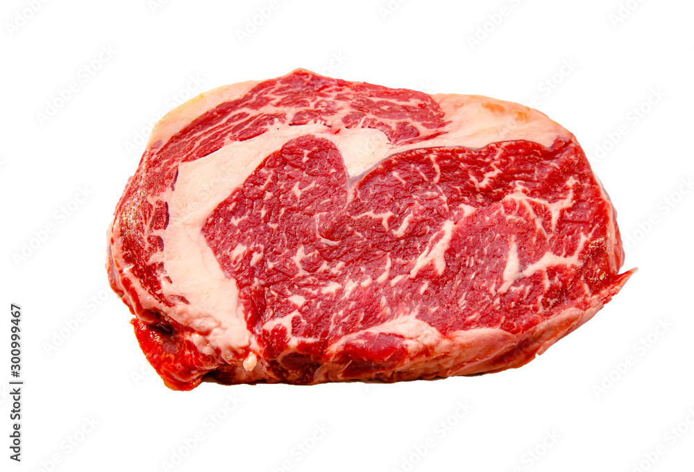 A rib eye steak of marbled grain-fed beef lies on a white background. Isolated. A rib eye steak of marbled grain-fed beef lies on a white background. Isolated.