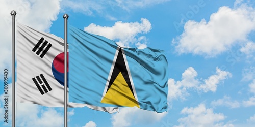 South Korea and Saint Lucia flag waving in the wind against white cloudy blue sky together. Diplomacy concept, international relations.
