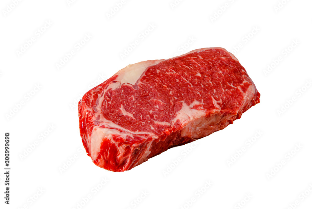 A rib eye steak of marbled grain-fed beef lies on a white background. Isolated.
