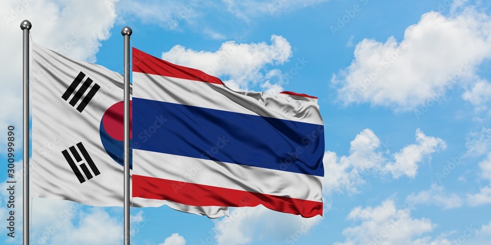South Korea and Thailand flag waving in the wind against white cloudy blue sky together. Diplomacy concept, international relations.